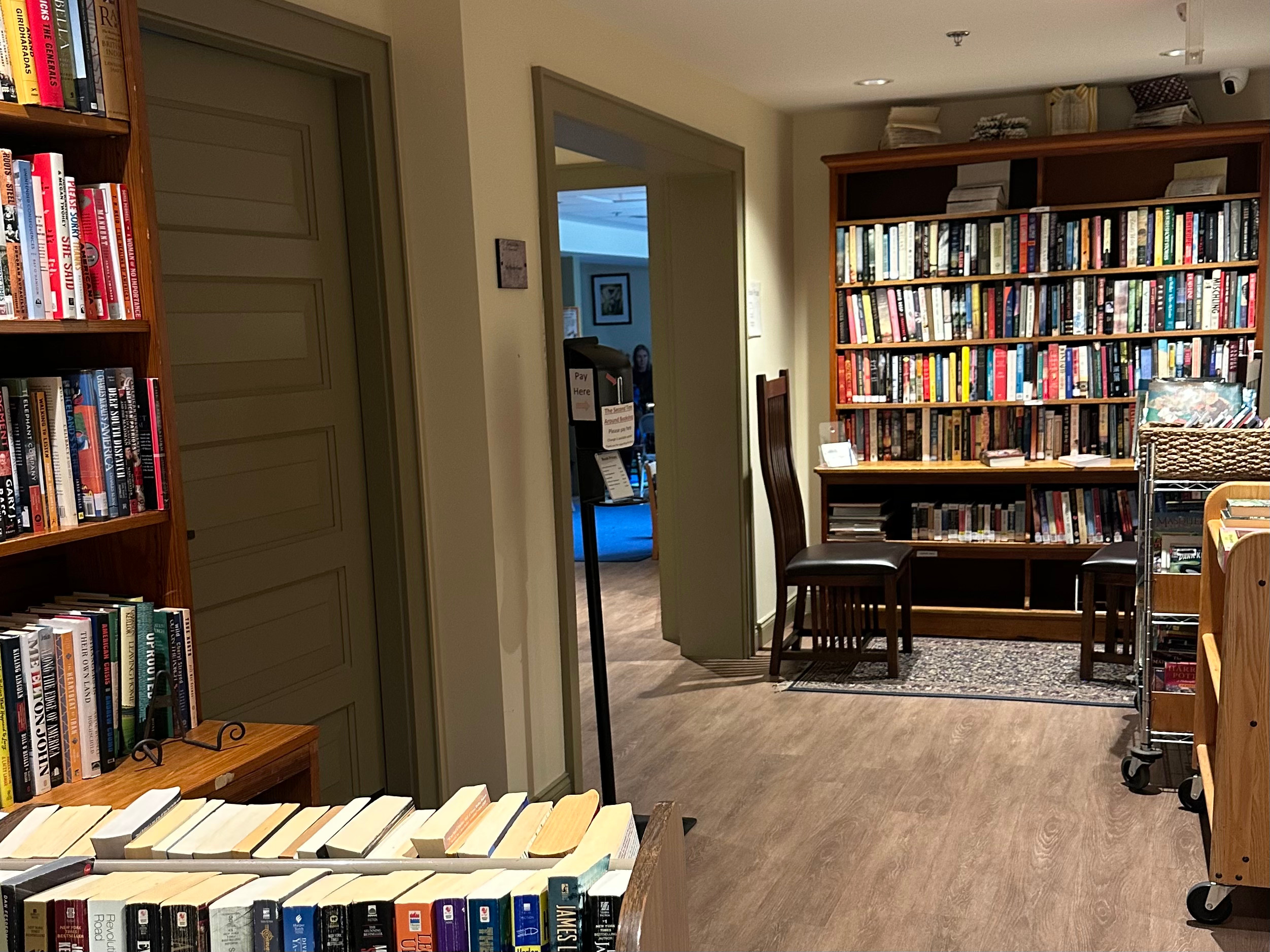 interior of West Falmouth Library used book shop. Filled bookshelves